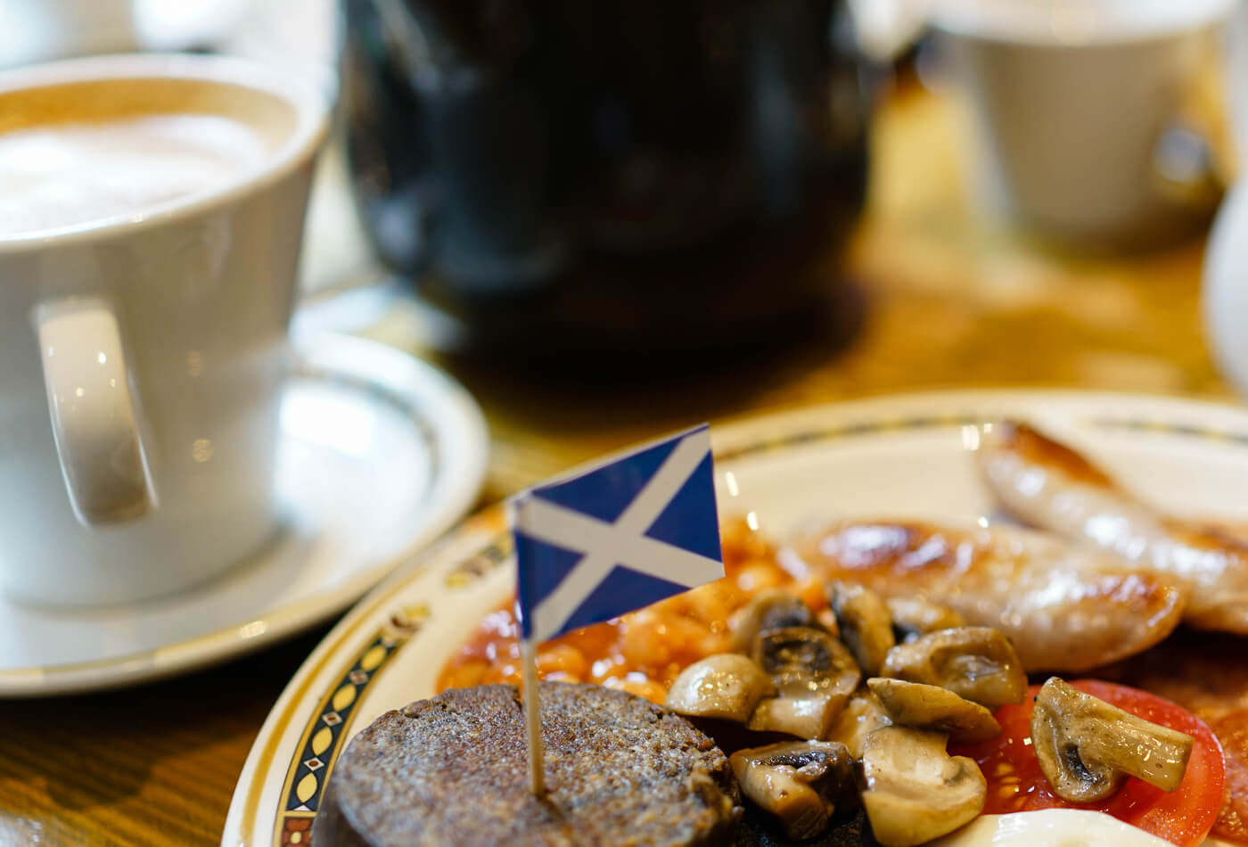 A fried breakfast with a Scottish flag in the black pudding